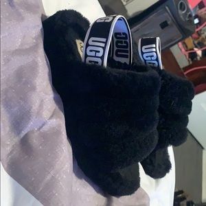 Black fluffy UGG slides